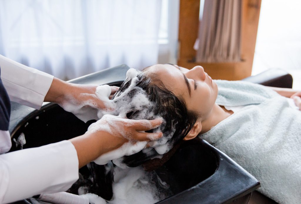 hair washed in beauty salon. happy young woman hair treatment