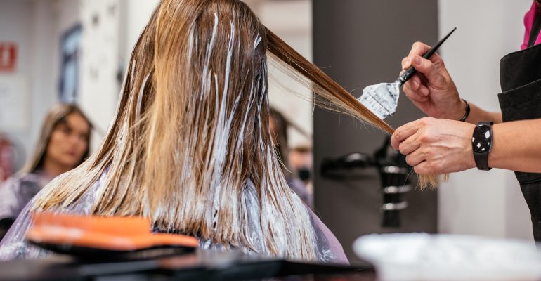 Hairdresser dyeing a woman's hair